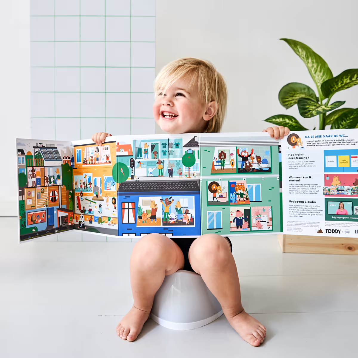 Kind op potje met prentenboek van Plasklas