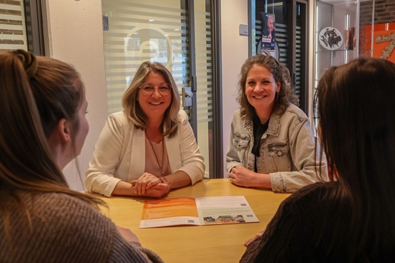 Sarina en Yvet in het gemeentehuis in Reuver in gesprek met 2 personen.